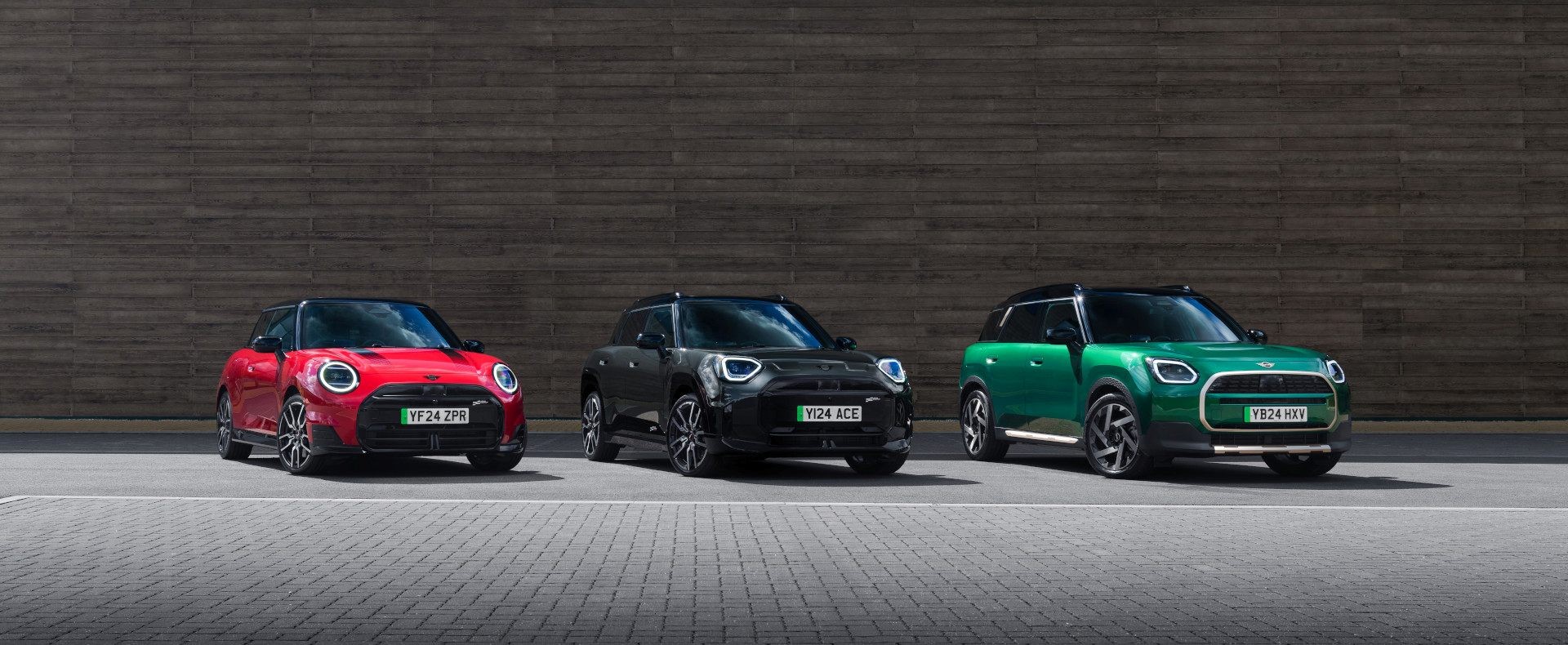 Electric MINI Cooper, Electric MINI Aceman and Electric MINI Countryman in a business parking lot